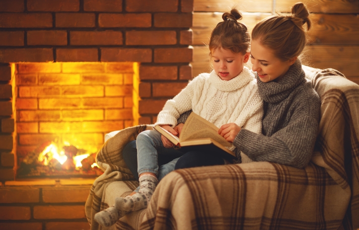 family warm in front of a gas fireplace