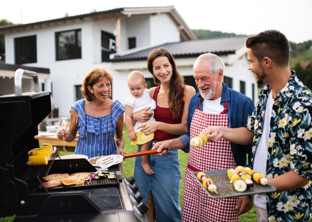 Family around the propane grill