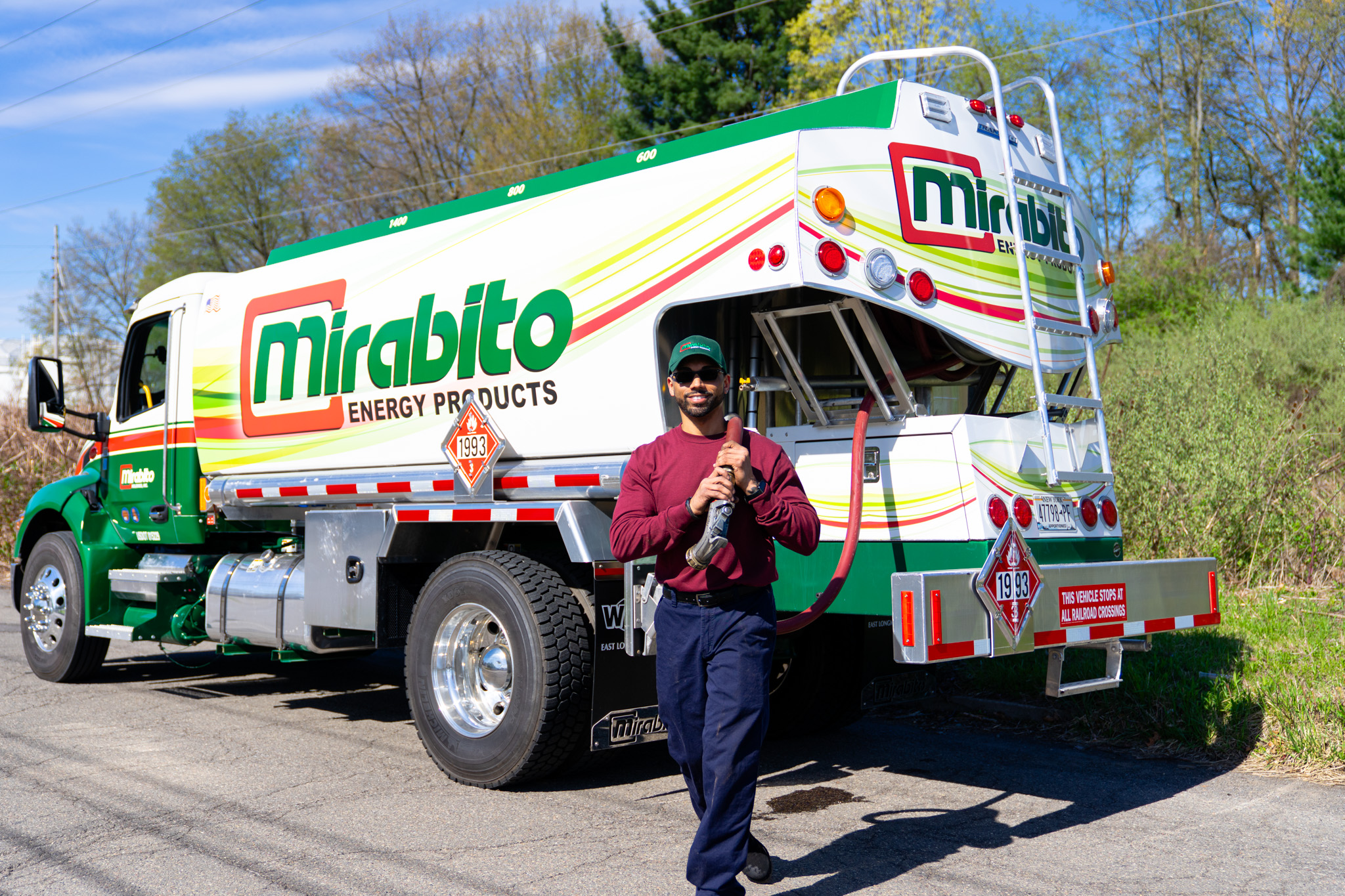 Mirabito oil truck with driver holding hose
