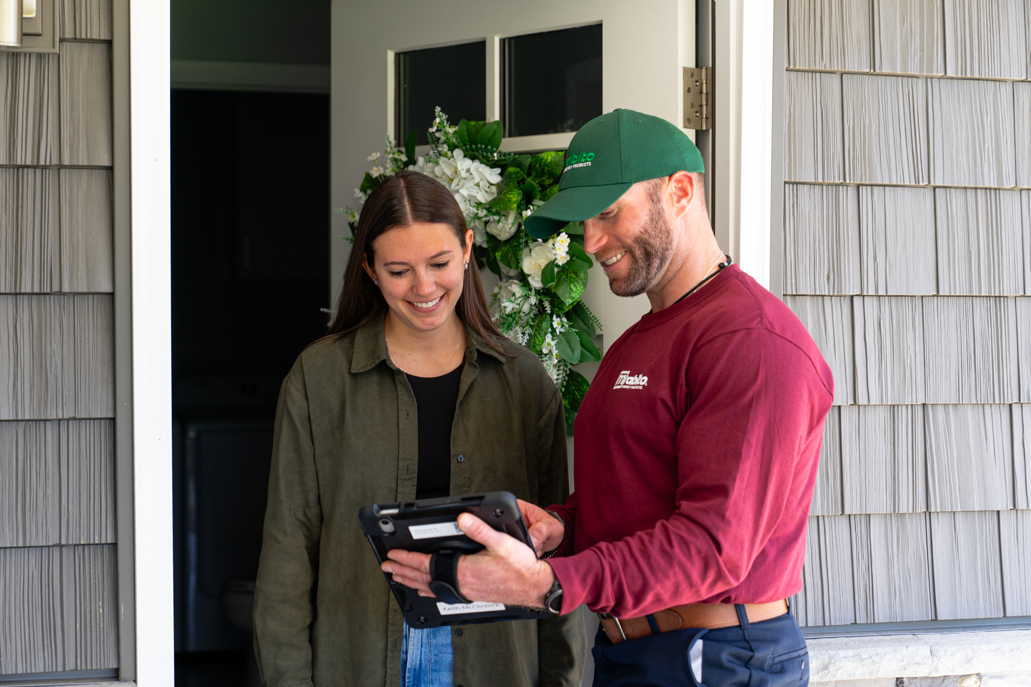 Mirabito service tech with customer reviewing document on ipad